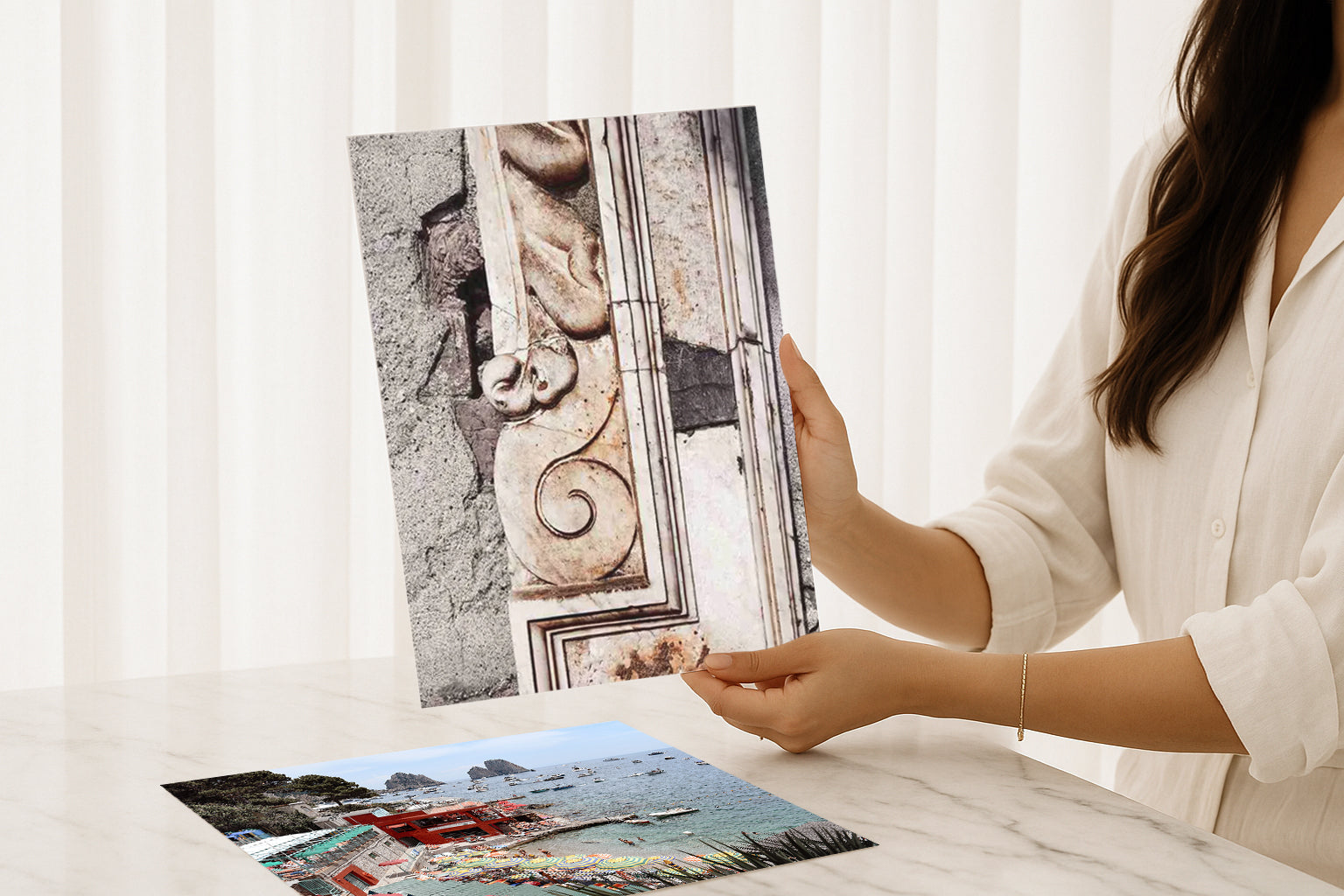 Woman holding a fine art travel photography print of Lake Como Italian stone texture with intricate detail, perfect as a Mediterranean wall art piece for luxury interiors.