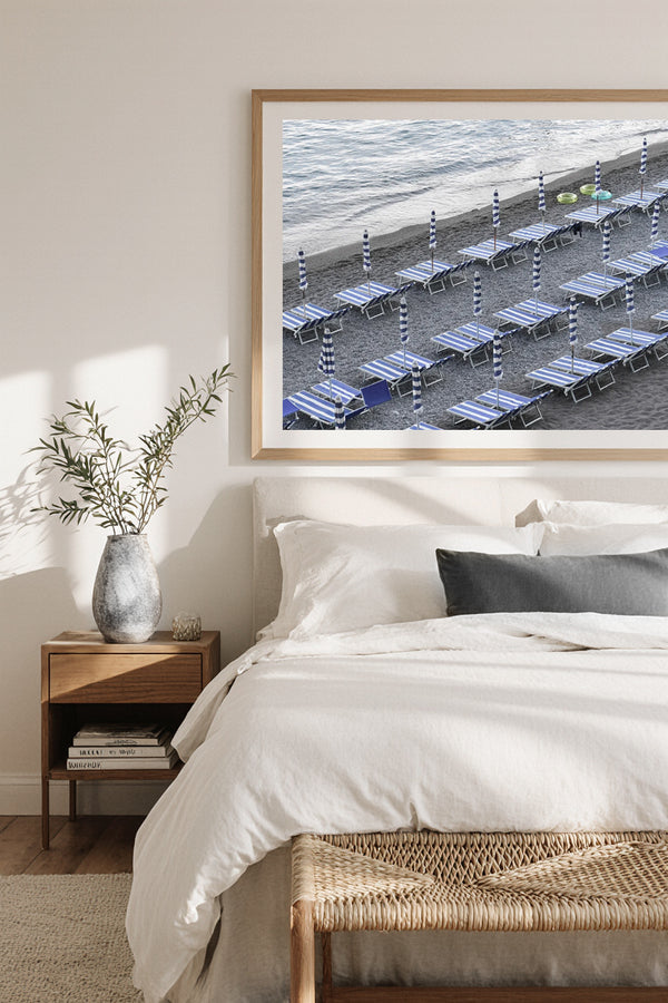 Minimalist fine art print of the Amalfi Coast, Italy, with rows of empty blue striped umbrellas and sun loungers on the beach, serene coastal Mediterranean photography.
