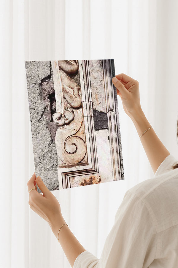 Person holding a travel photography print of Italian architectural stone texture and ruins. Fine art wall print for lovers of history and Mediterranean design.