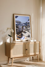 Art print of La Fontelina Beach Club in Capri, framed wall art leaning on a console with sunlight streaming in.